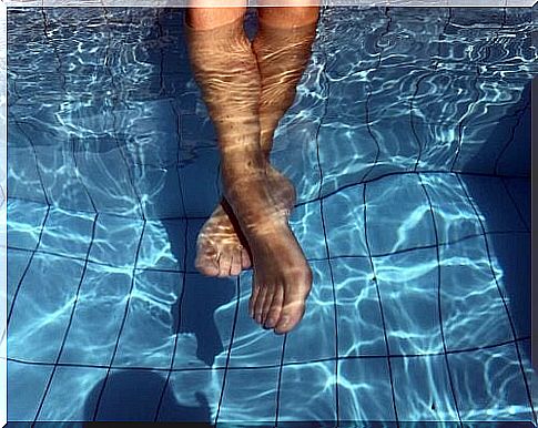 Feet submerged in swimming pool