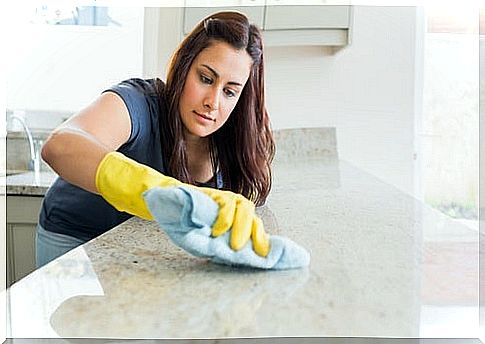 Woman cleaning the countertop with natural products