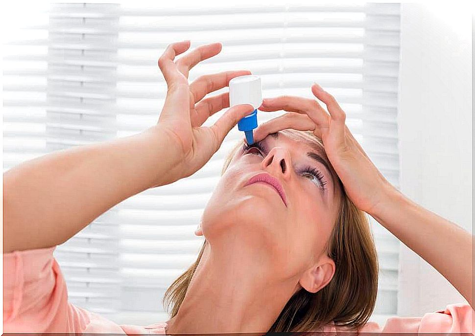 woman dripping eye drops