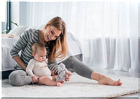 mother teaching baby to sit