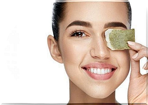 Woman with tea bag in her eye